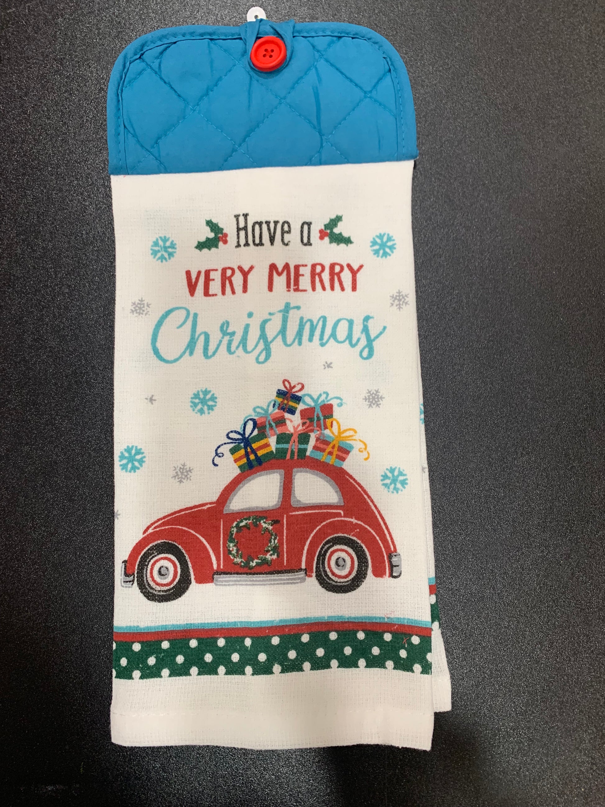 Christmas-themed hot pad with red car and text on a black background